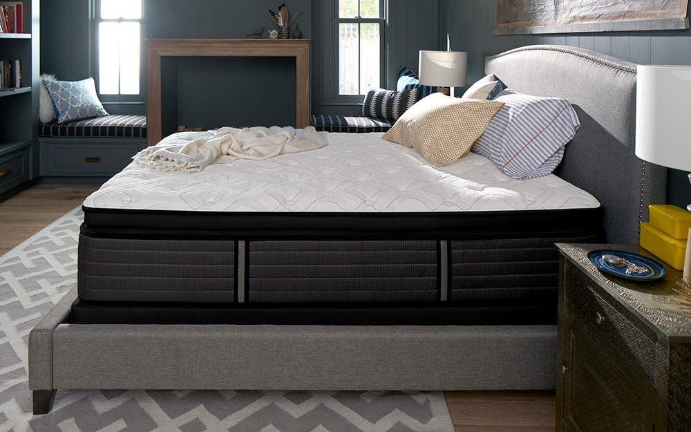 A stripped bed on a bed platform in a bedroom