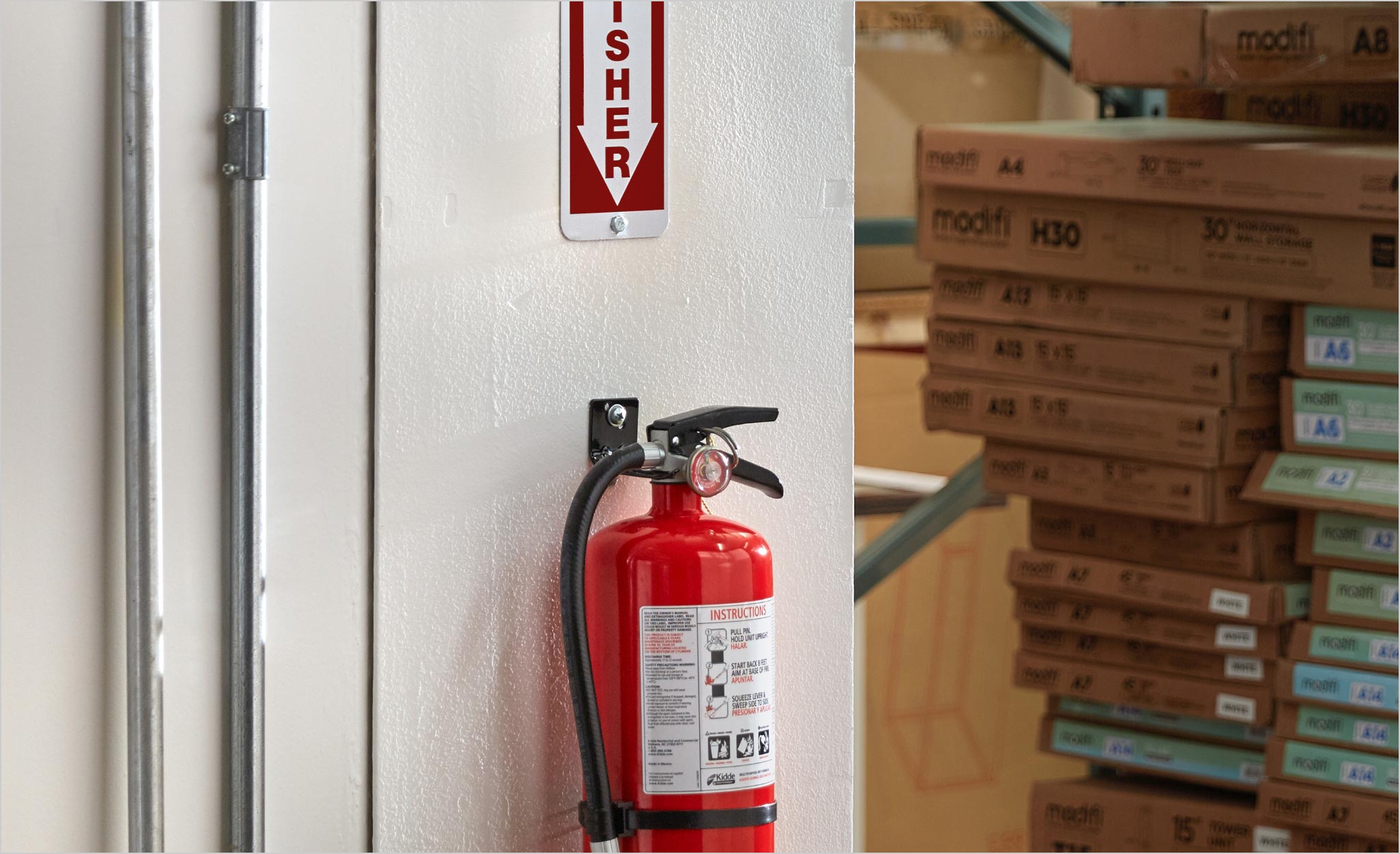 Wall Mounted Fire Extinguisher in a Warehouse of Type 2 Construction