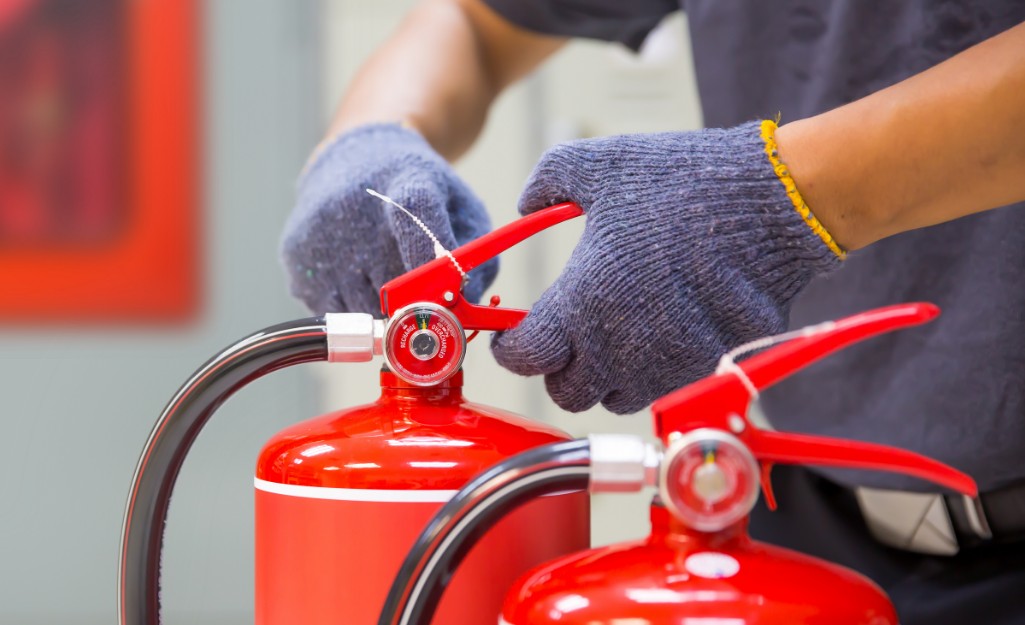 A Pro details a fire extinguisher handle and removes any debris.