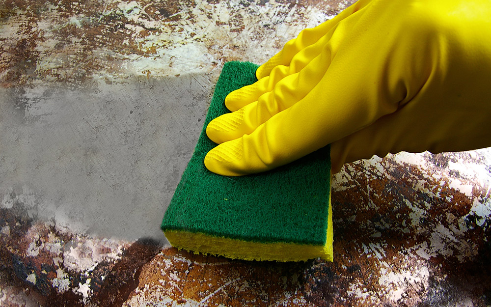 A cast-iron skillet with rust spots being cleaned. A cast-iron skillet with rust spots being cleaned.