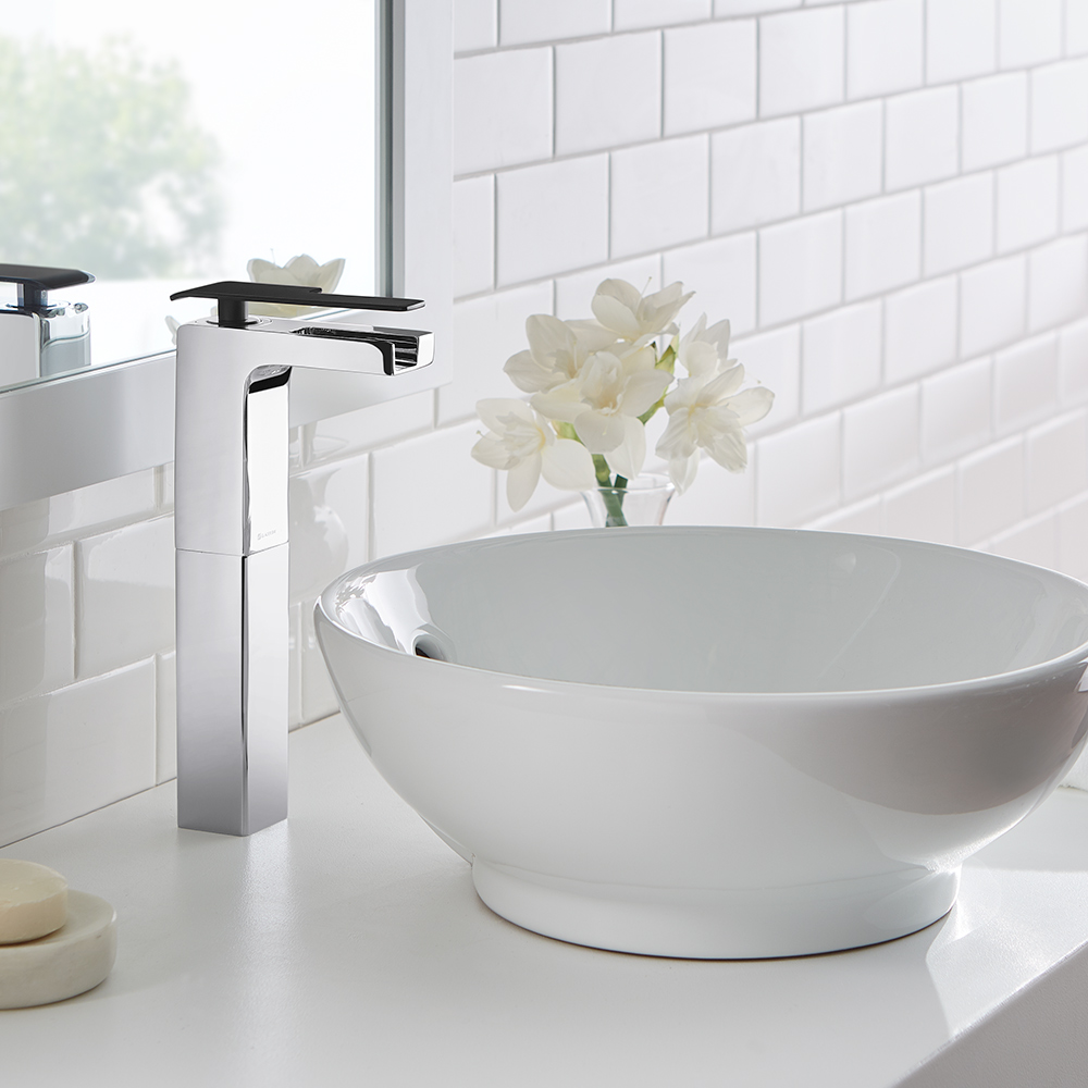 A Glacier Bay bath faucet installed in over a raised bowl sink.