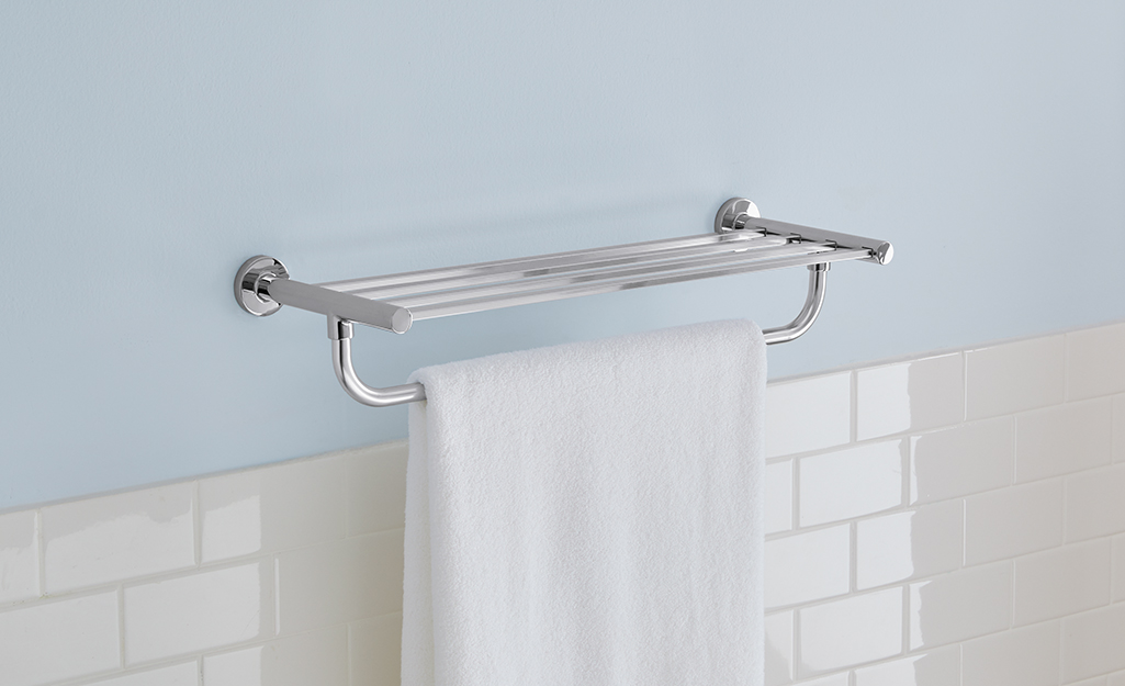 Silver Glacier Bay towel rack hanging on a bath wall.