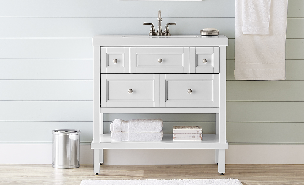 A white Glacier Bay vanity in a small bath.