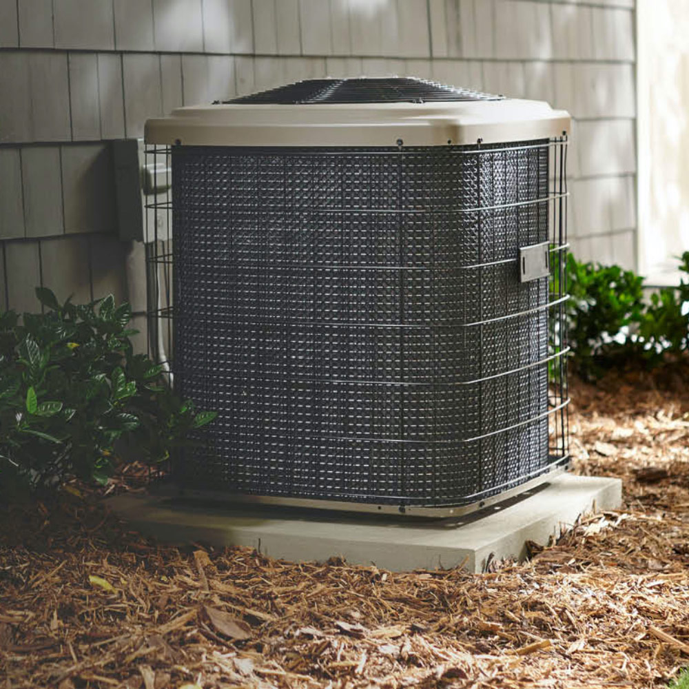 An air conditioner condenser outside a house.