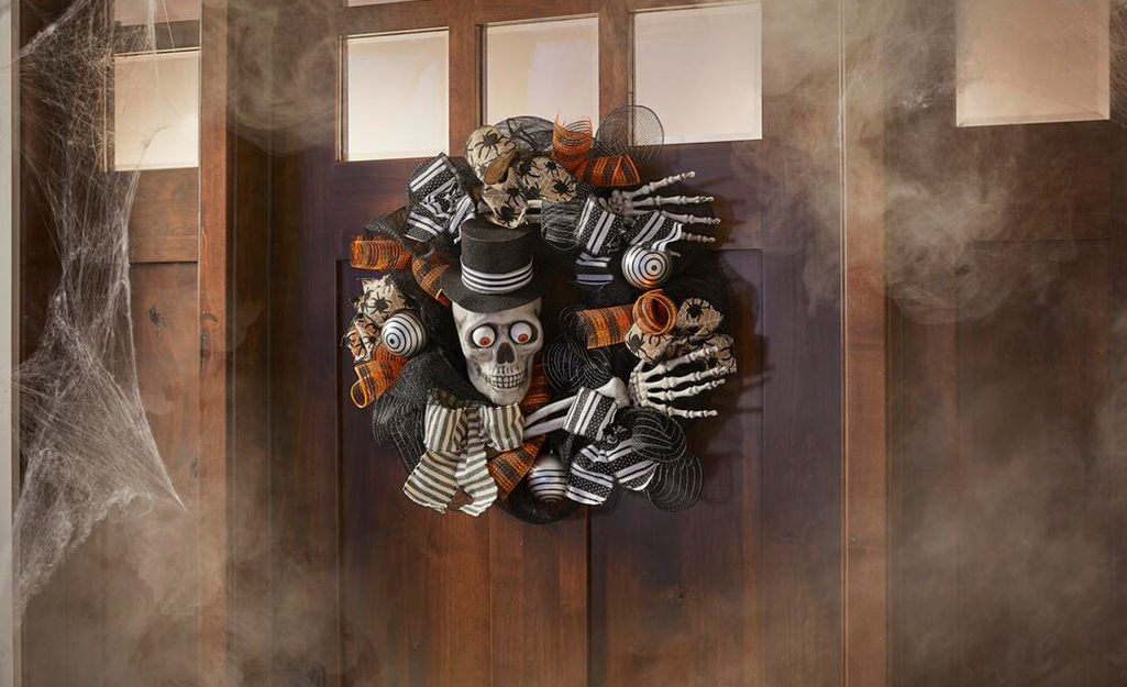 A Halloween-themed wreath on a door.