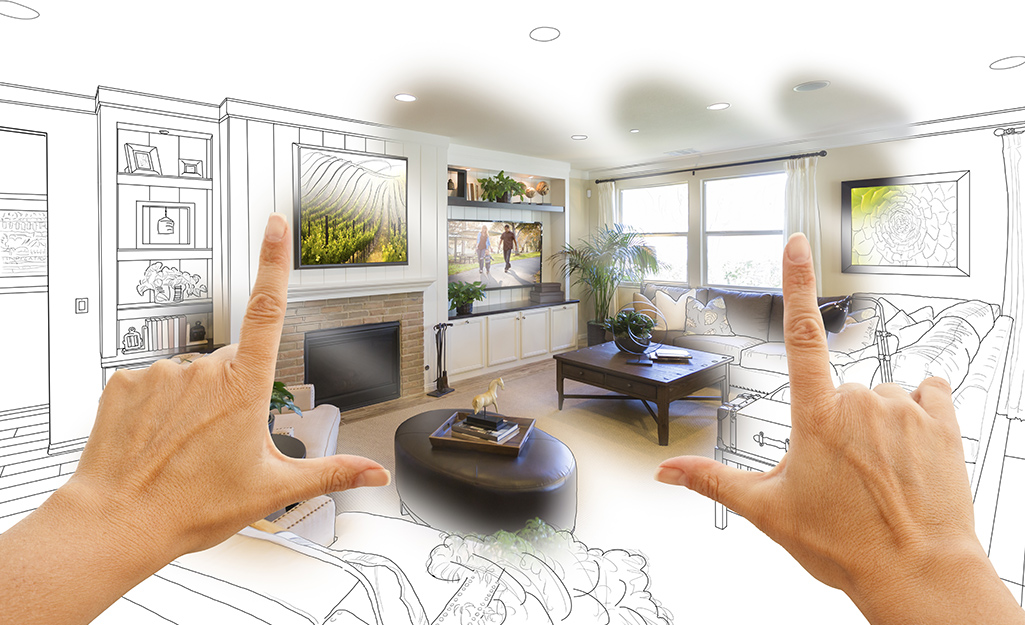 A person's hands frame an illustration of a new living room