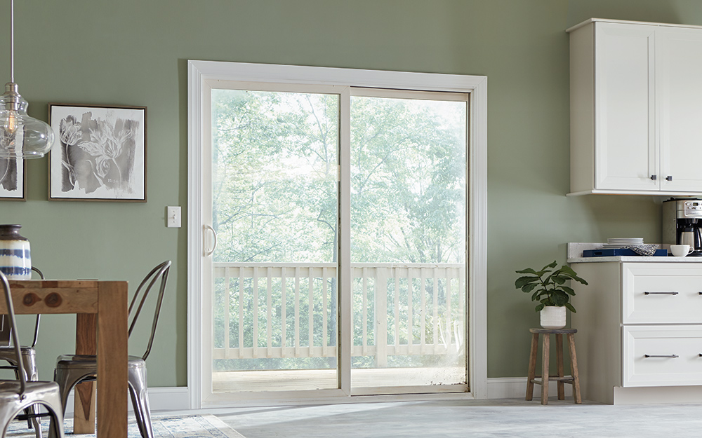 A white sliding door leads from the dining room to the deck.