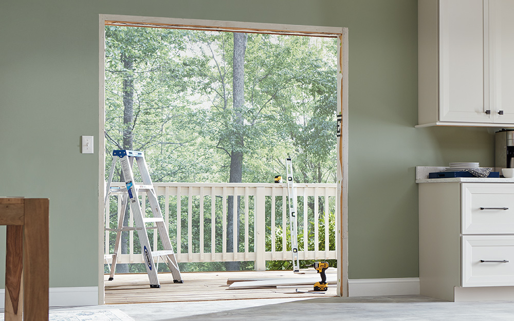 A door frame reveals the outside deck railing.