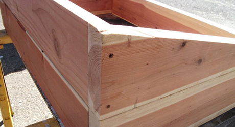 A wedge makes up the top section of a side of a cold frame.