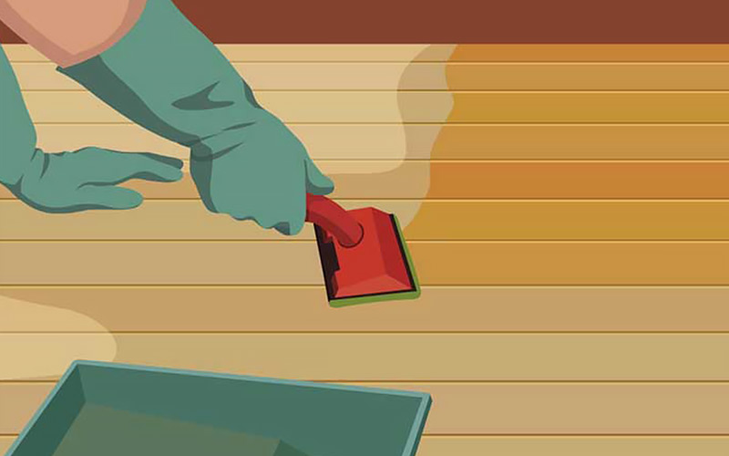An illustration shows a person using applying stain to a hardwood floor. An illustration shows a person using applying stain to a hardwood floor.