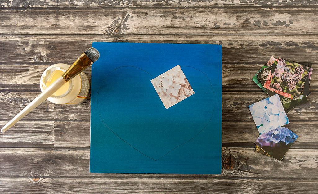 A square piece of wood with a photo glued on it.