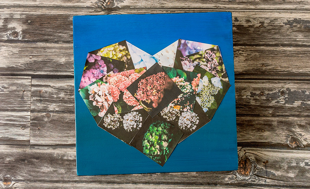 A heart shaped photo collage on a table.