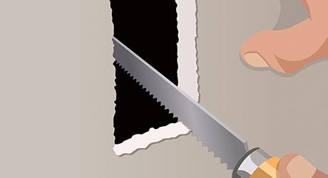 A person cutting a hole in drywall during line voltage installation. A person cutting a hole in drywall during line voltage installation.