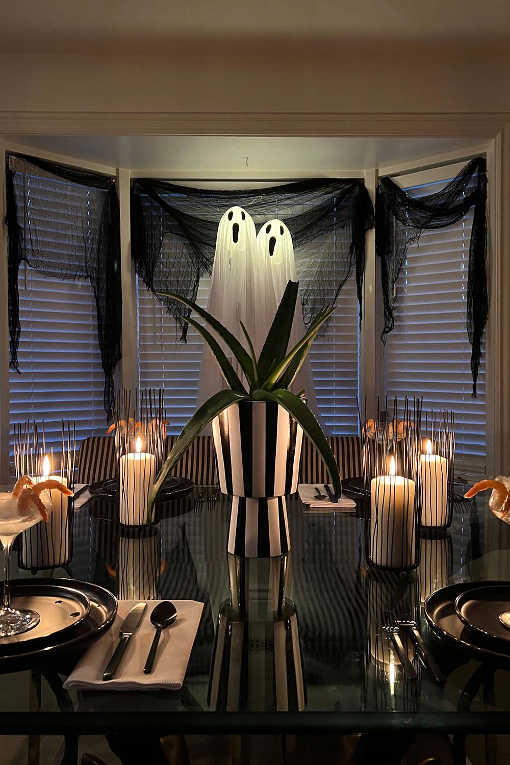 Dining room set up with Halloween decorations in a night setting.