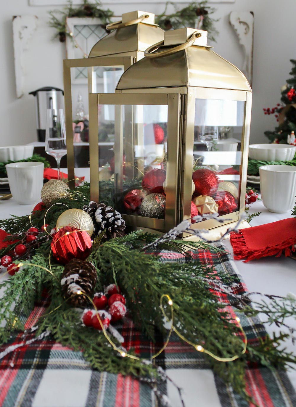 Gold Lantern surrounded by red gold and green holiday ornaments