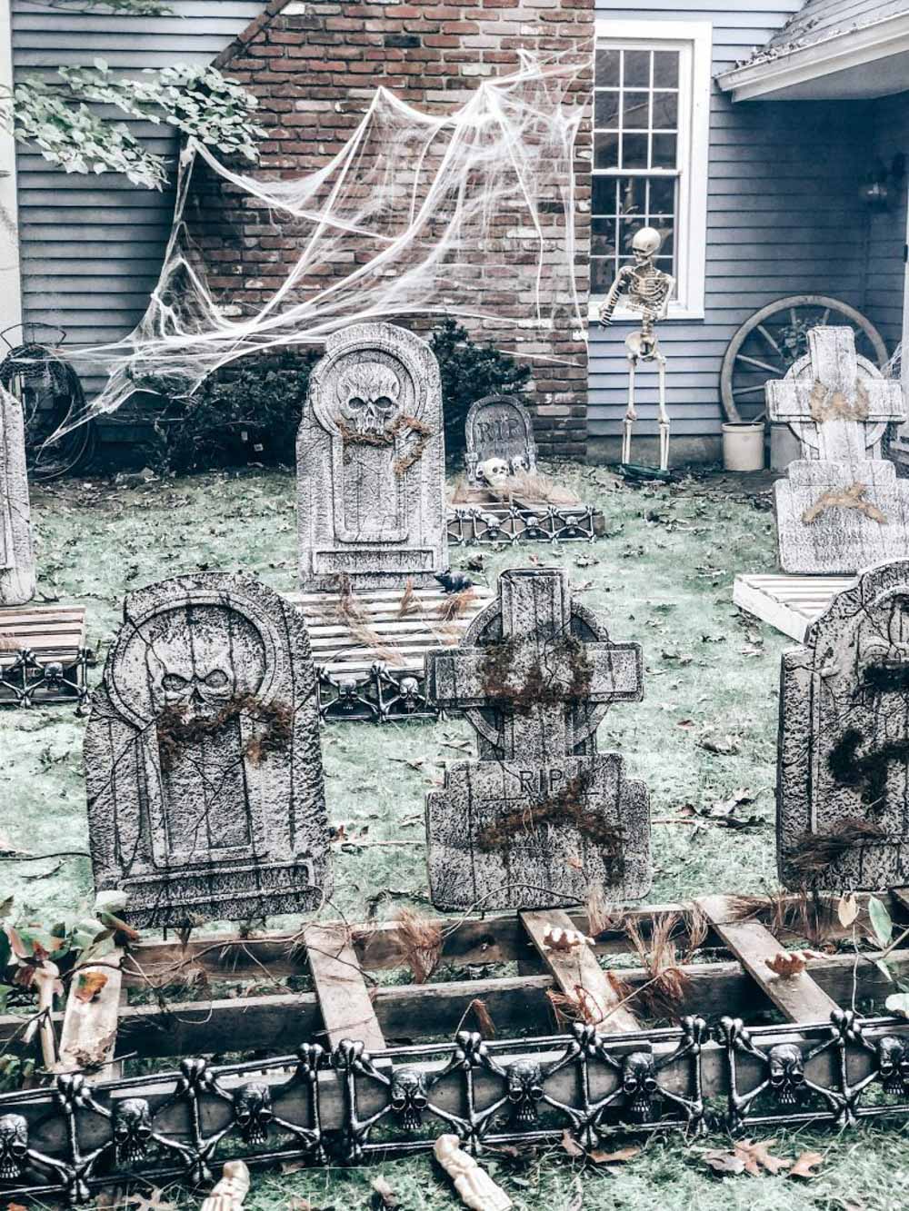 A cemetery filled with tombstones and spider webs.