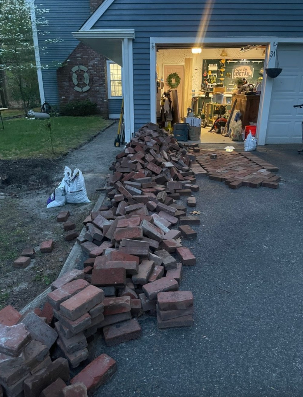 Driveway filled with a pile of bricks.