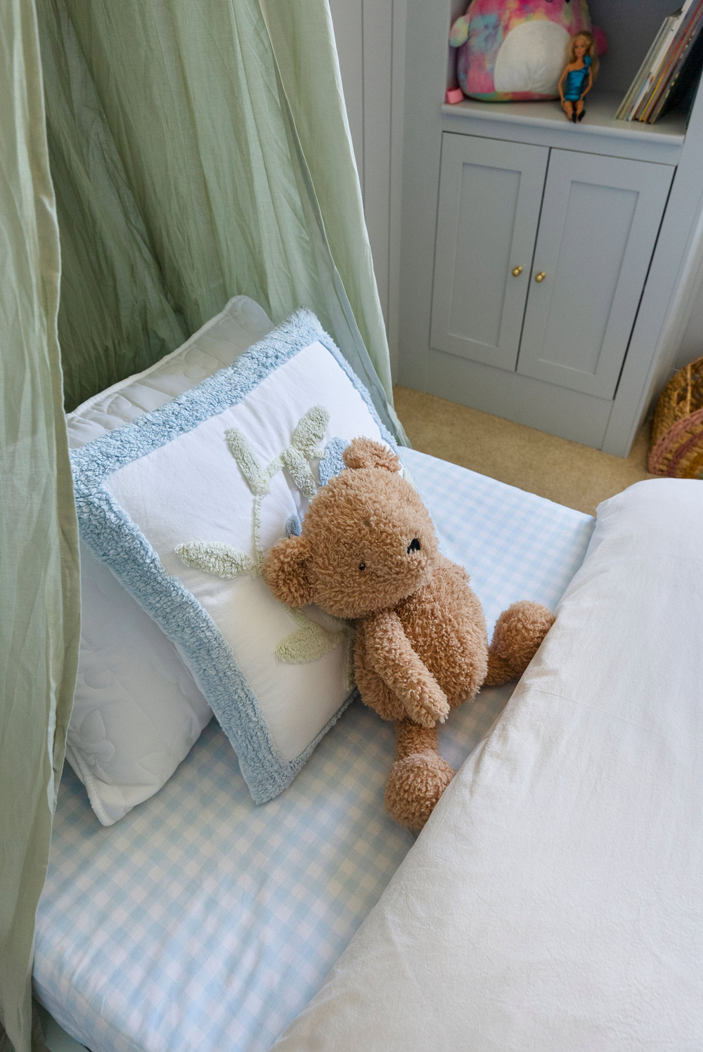 Overhead shot of a kid’s bed with pillows and a teddy bear in the center. Overhead shot of a kid’s bed with pillows and a teddy bear in the center.