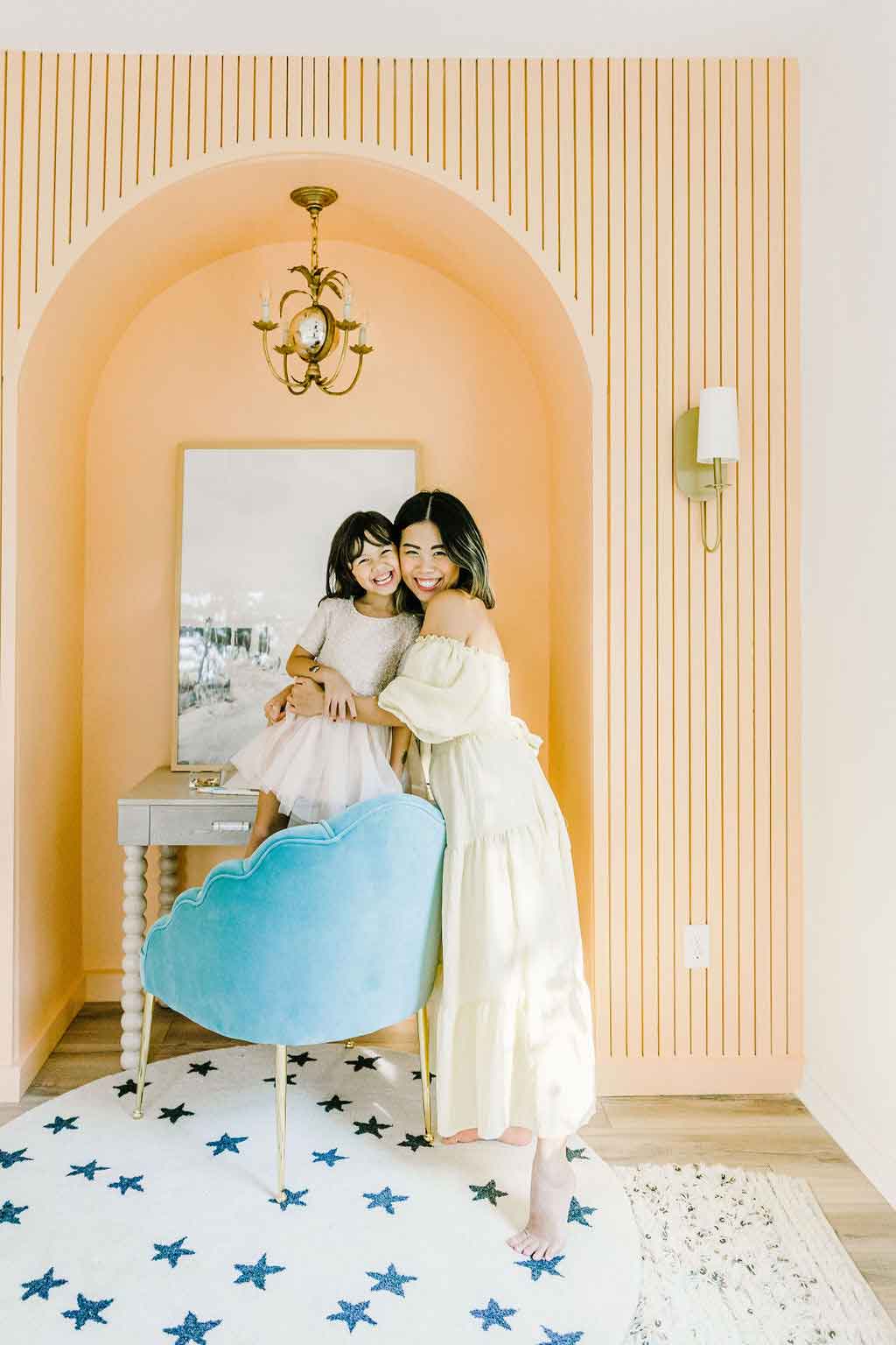 Joy green and her daughter standing on bright fresno cream colored arch Joy green and her daughter standing on bright fresno cream colored arch