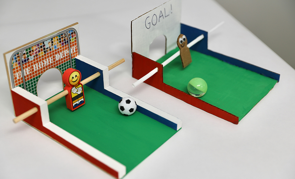 Two table top soccer games on a table. Two table top soccer games on a table.