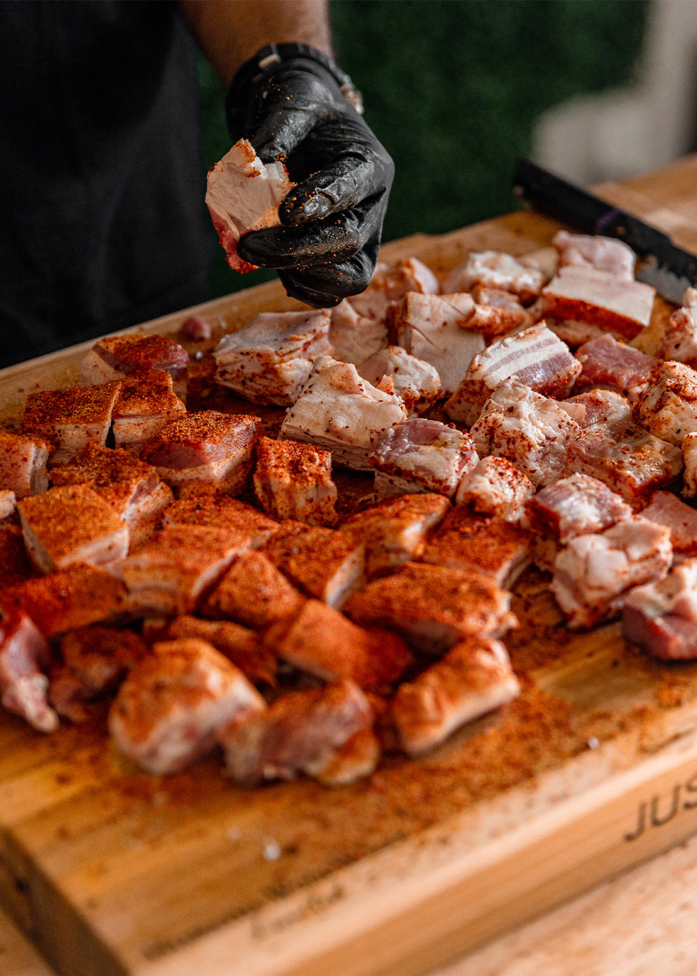 Chef seasoning pork belly on cutting board. Chef seasoning pork belly on cutting board.