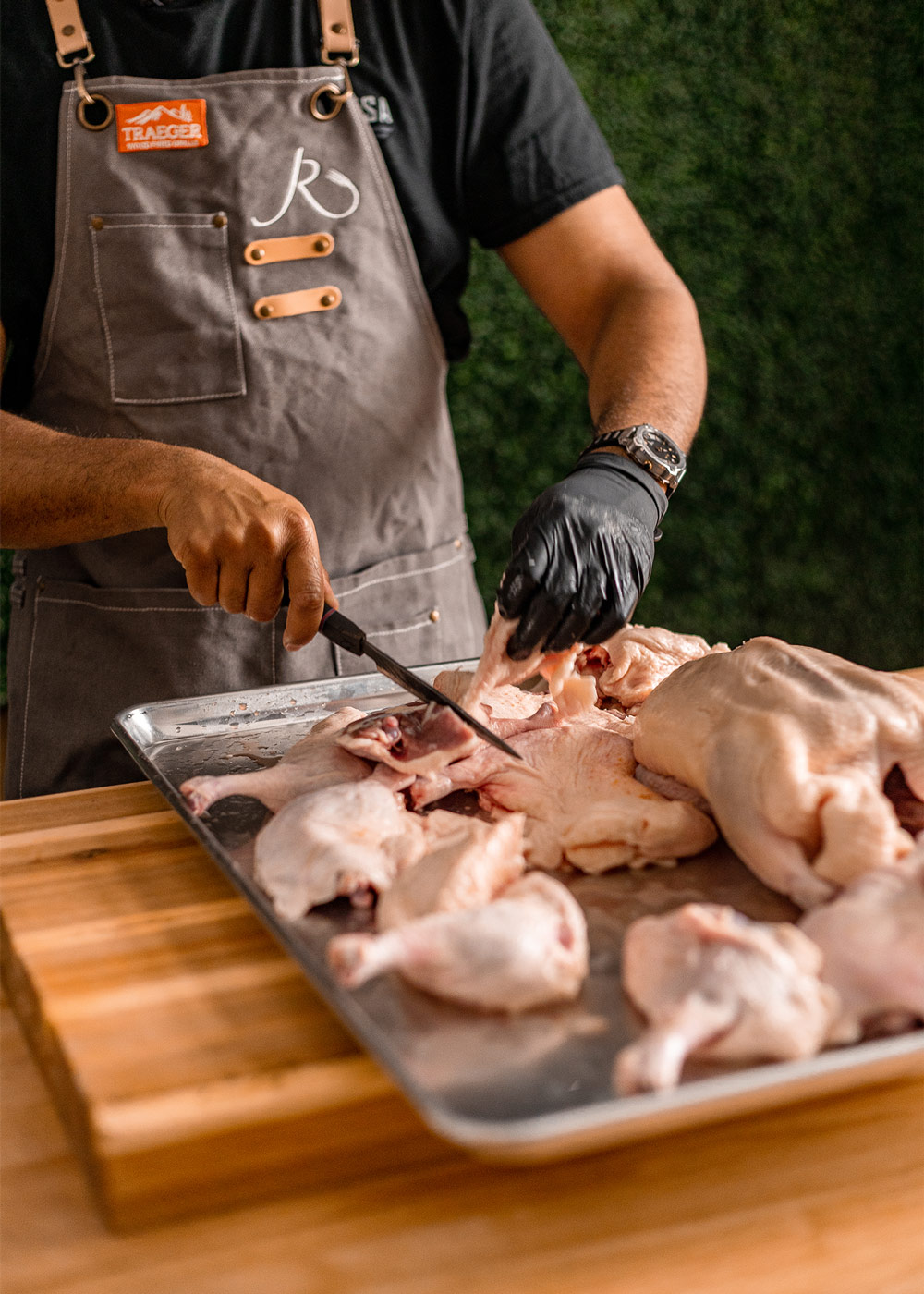 Chef cutting raw duck legs. Chef cutting raw duck legs.