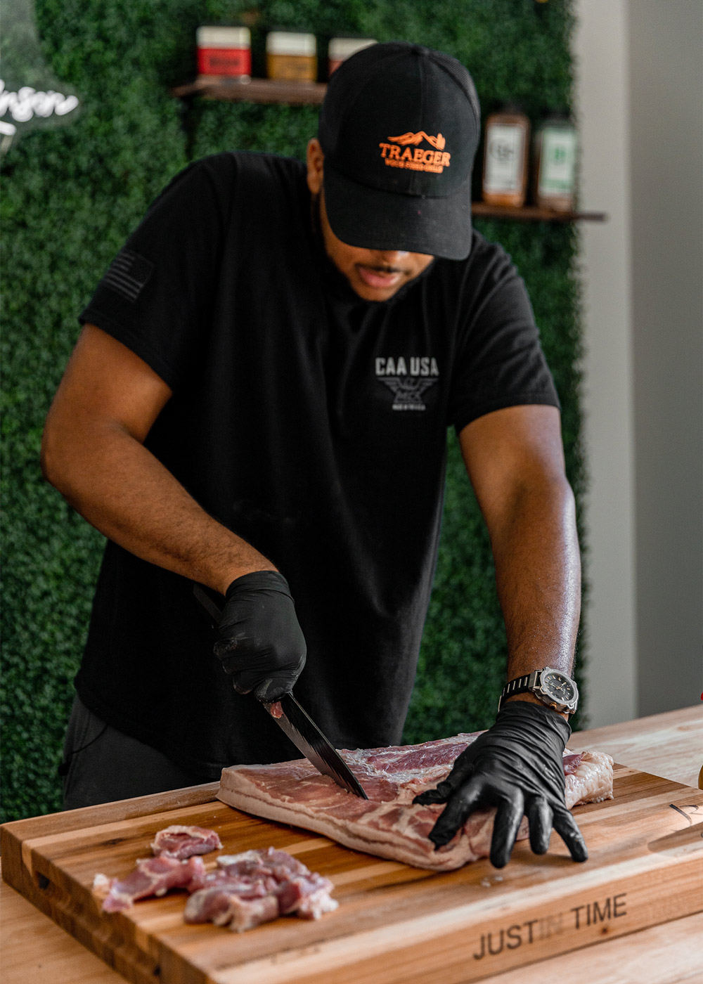 A chef cutting pork belly. A chef cutting pork belly.