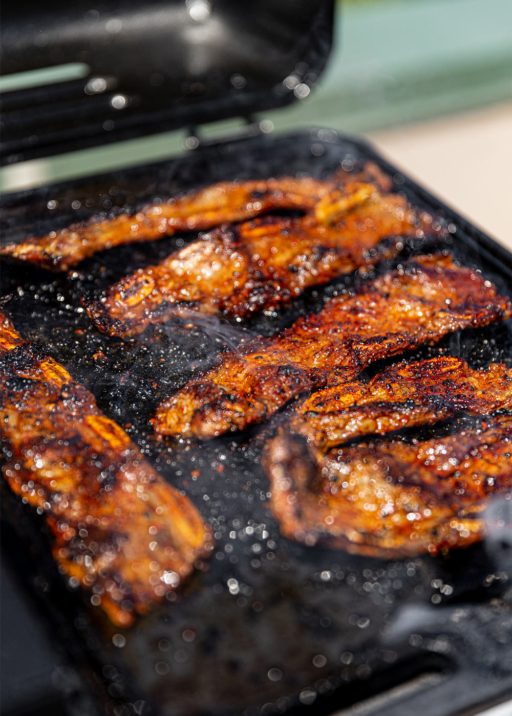 Cooked riblets on griddle. Cooked riblets on griddle.