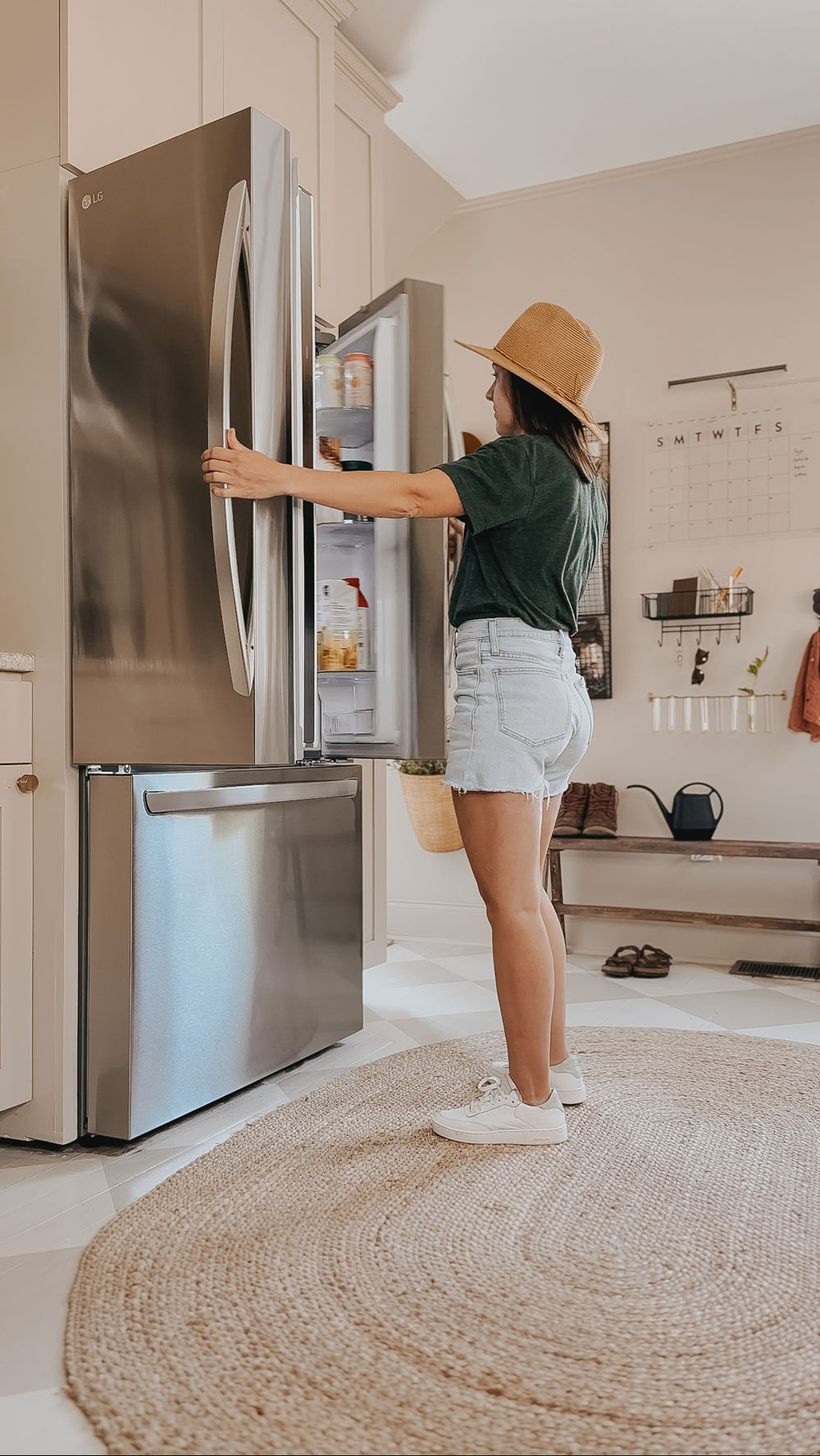  A person opening a refrigerator.
