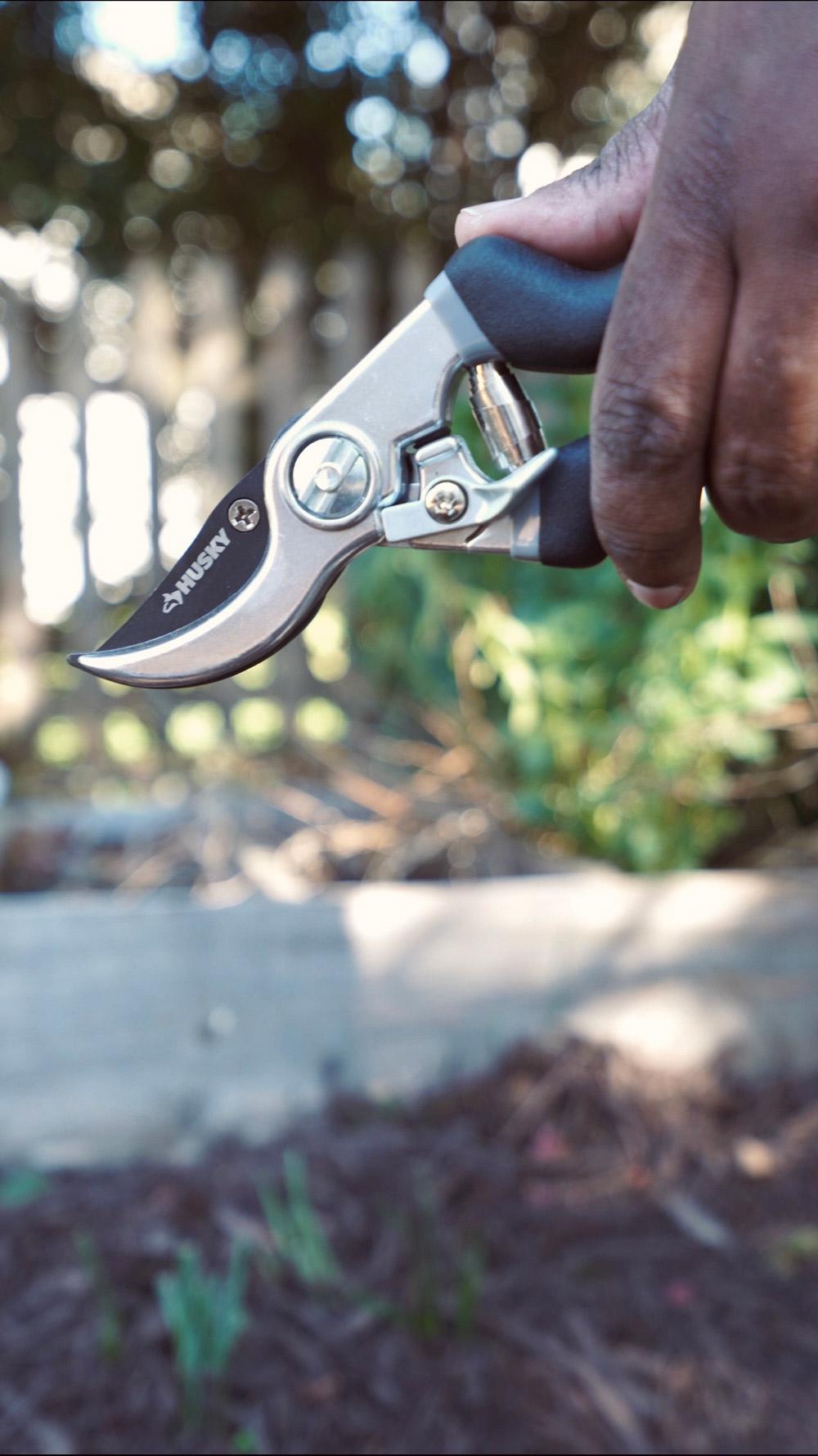 A Person holding Husky Pruning Sheers.