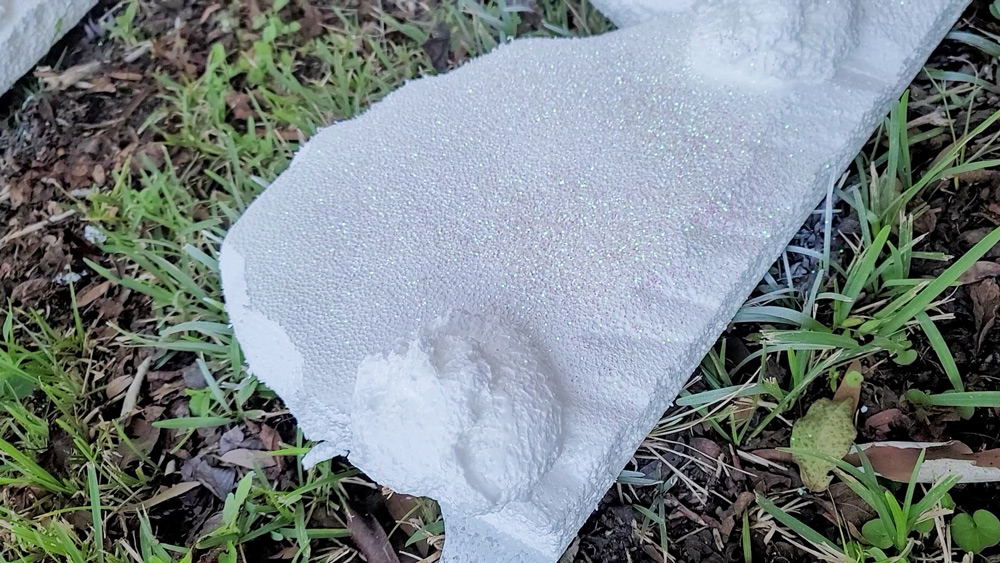 A piece of styrofoam with spray foam to mimic icing.