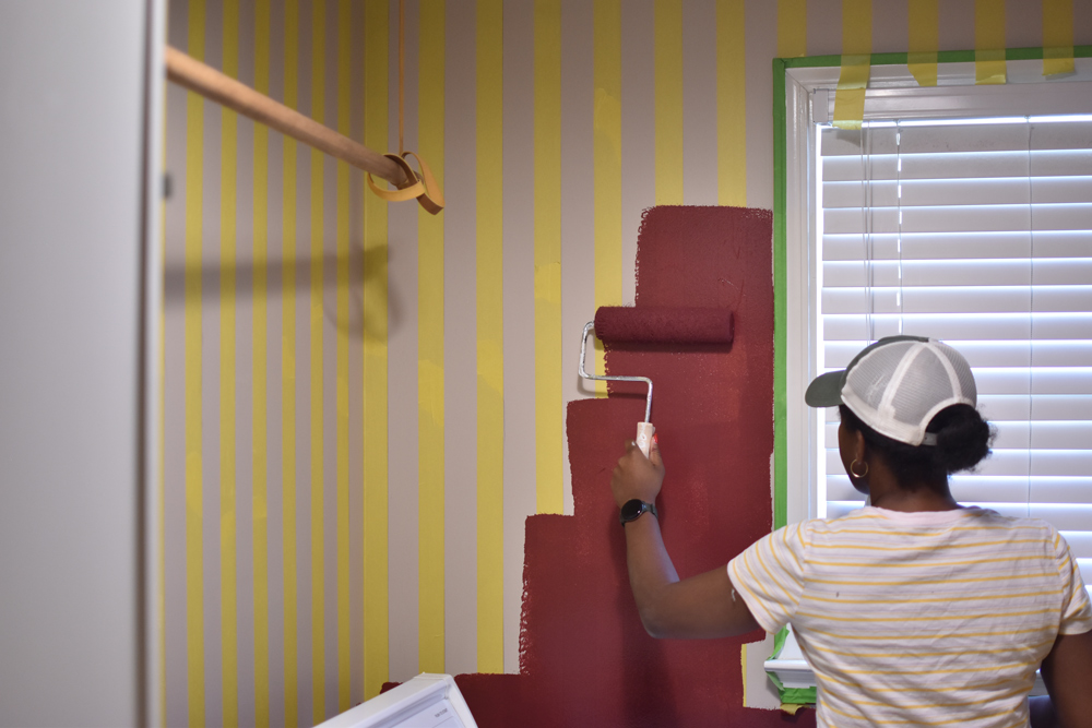 A person painting a wall.