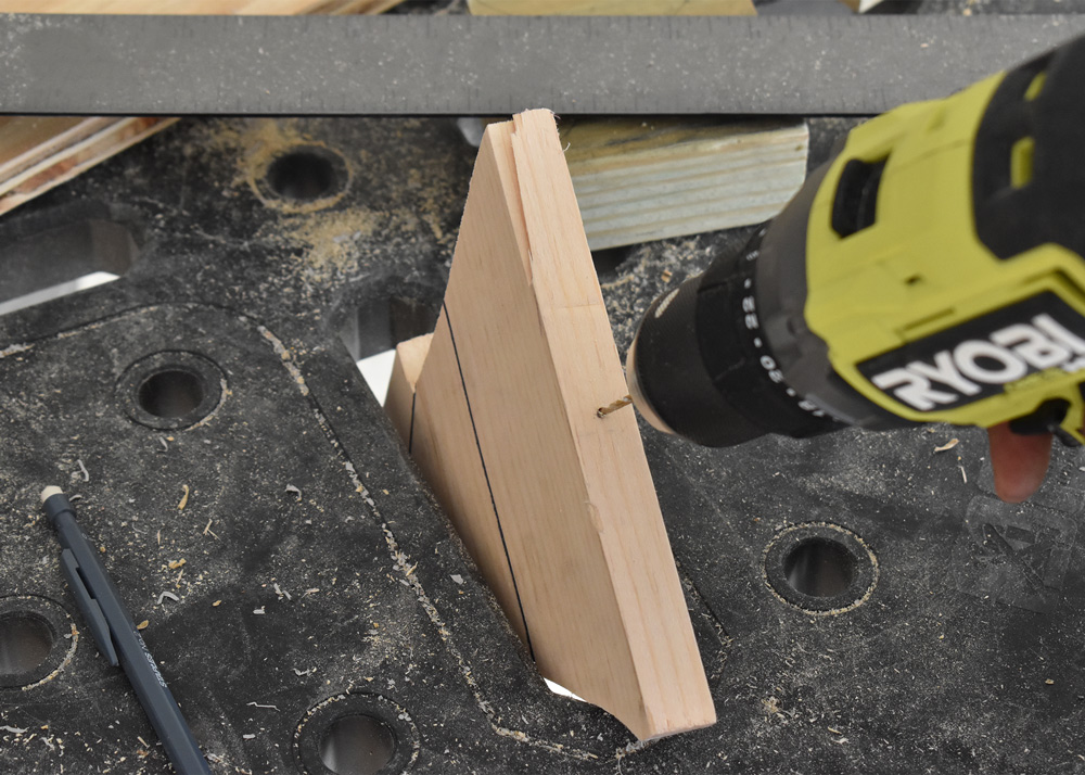Person drilling hole in 2x4s