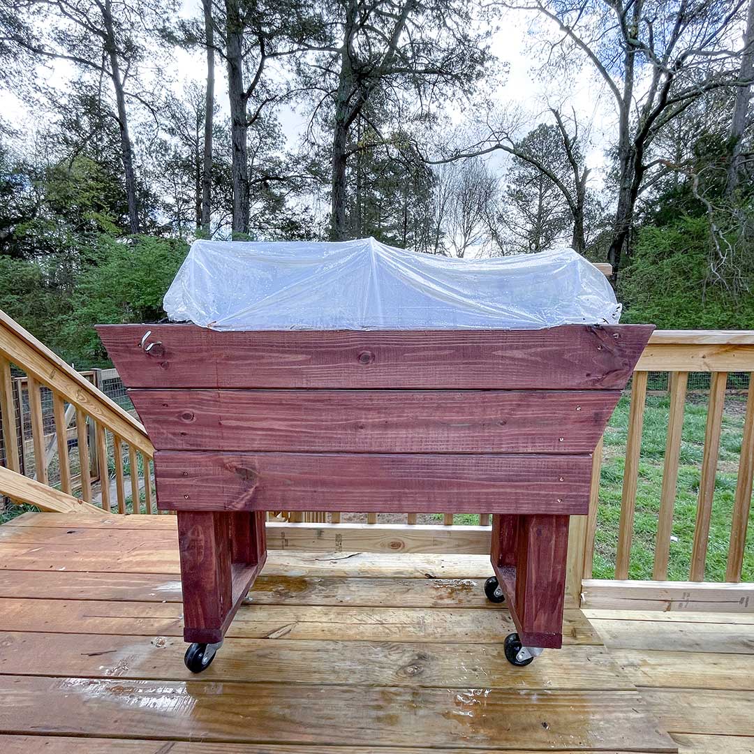 A finished, stained rolling veggie cart.