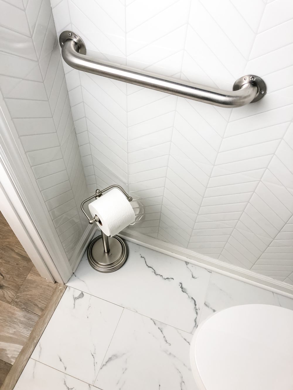ADA Grab bar featured with peel and stick wall tile.