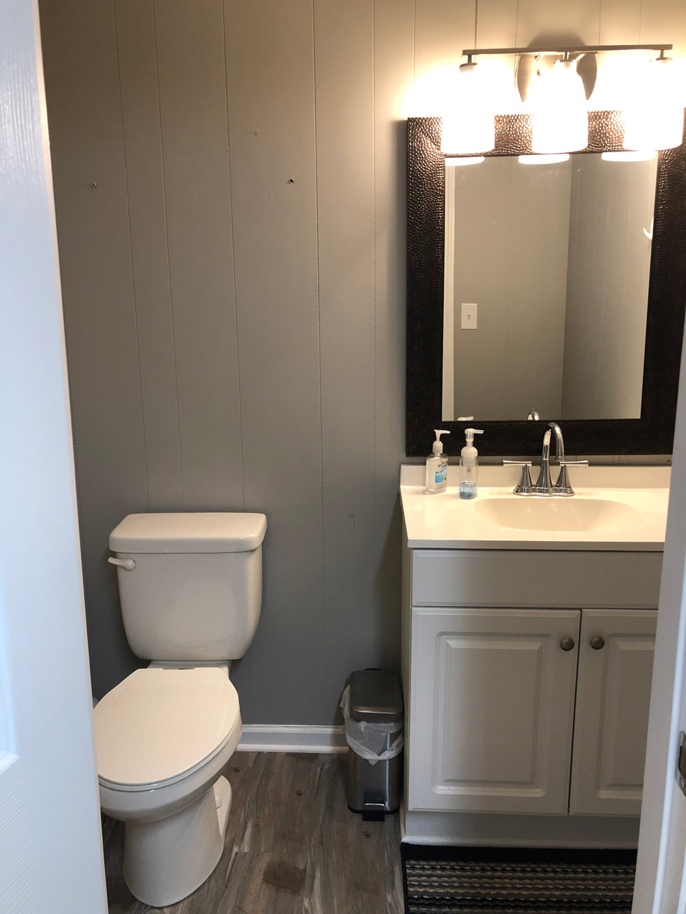 Bathroom featuring toilet and sink before renovation.