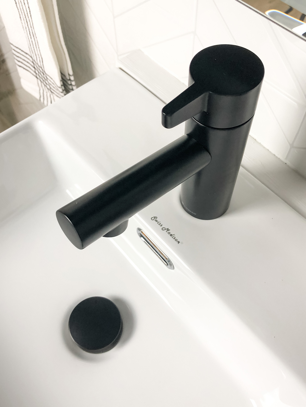 Black touchless faucet featured with white vessel sink