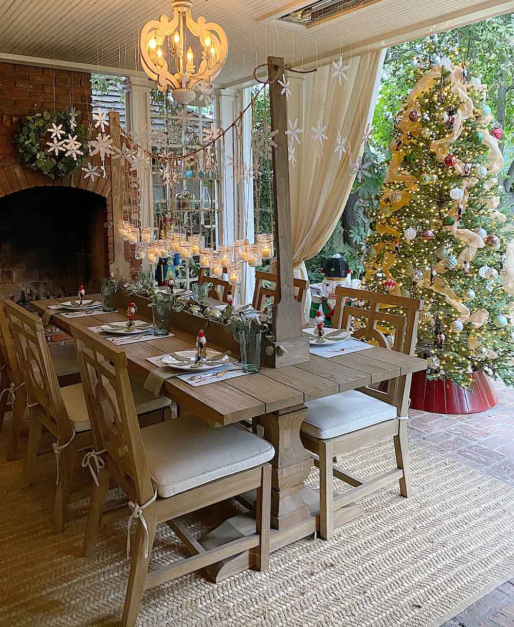 Dining room featuring fireplace with wreath. Styled with holiday decor and a Christmas tree in the background