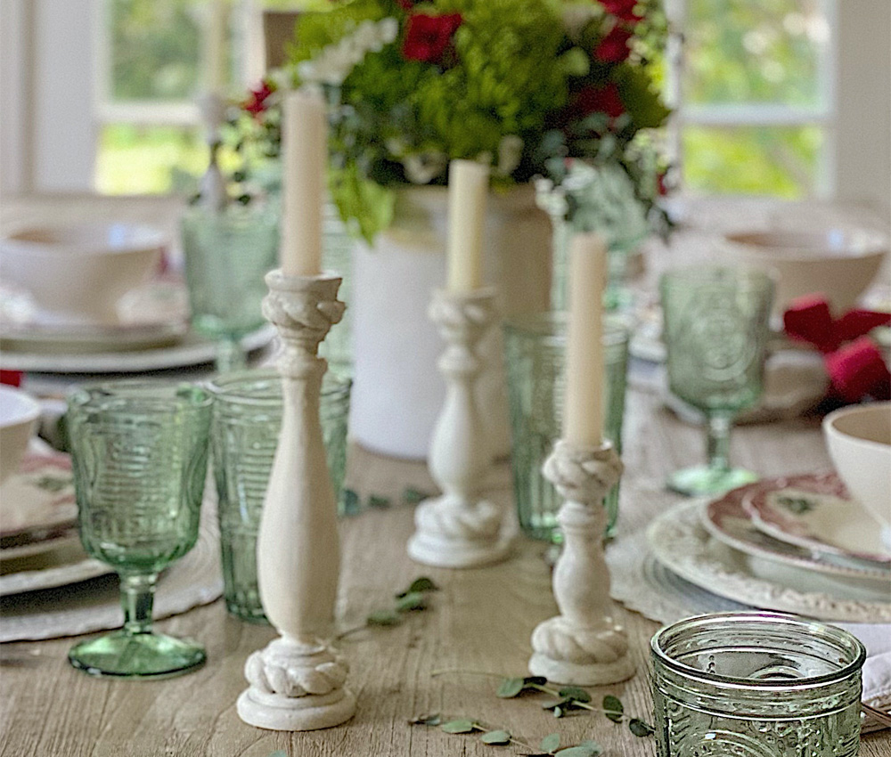 Candles and flowers on a dining table spread. Candles and flowers on a dining table spread.