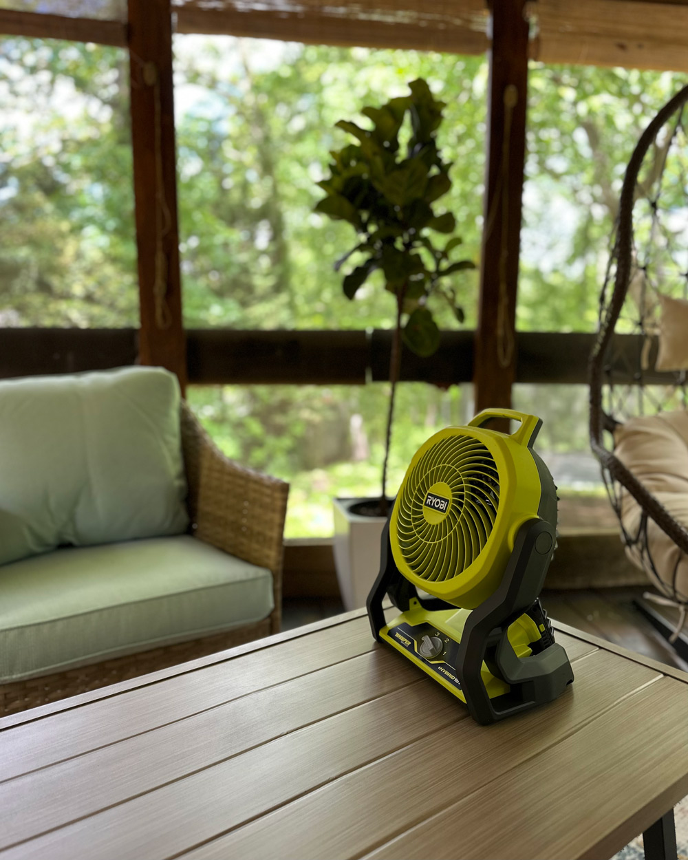 A small cordless Ryobi fan sitting on a table. A small cordless Ryobi fan sitting on a table.