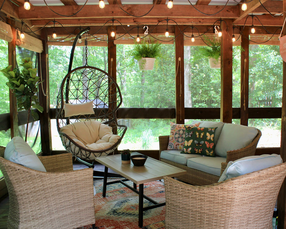 Patio with egg chair, hanging plant, string lights, and a patio table set. Patio with egg chair, hanging plant, string lights, and a patio table set.
