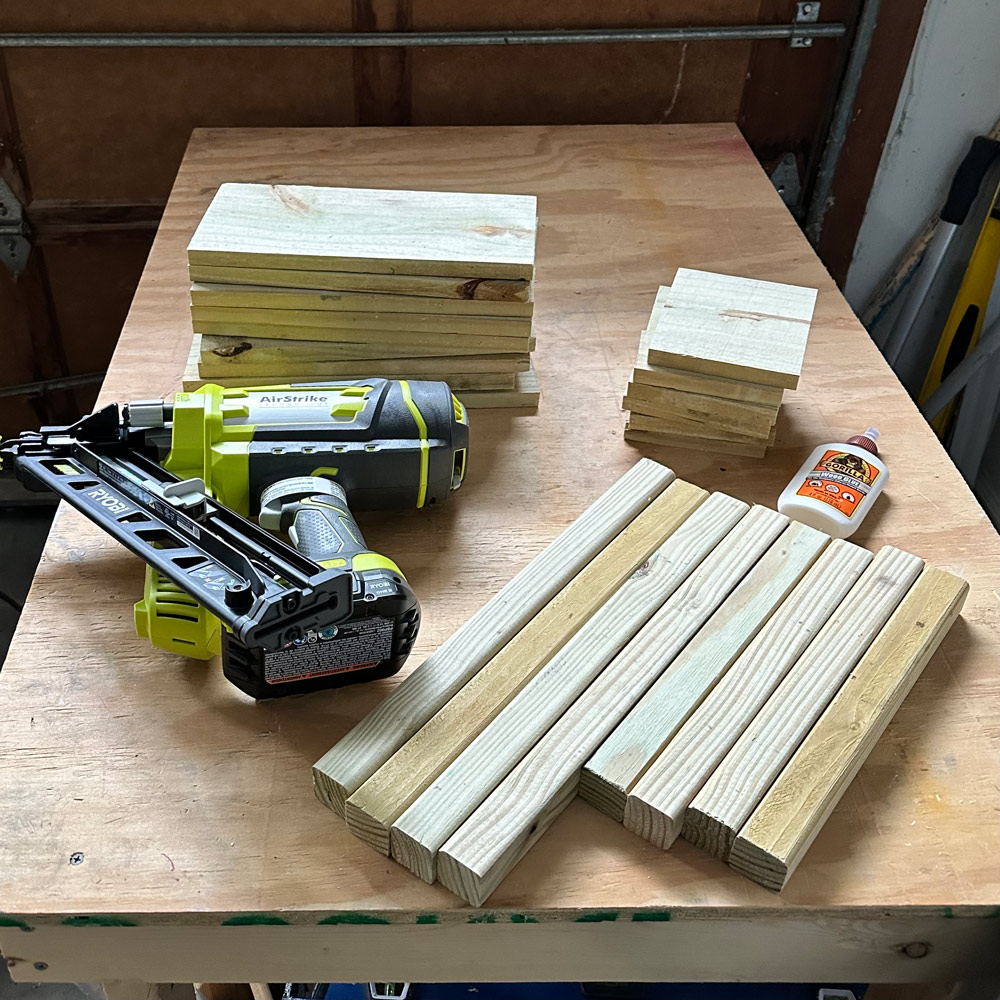 Gorilla glue, a Ryobi nailer, and wood planks on a table. Gorilla glue, a Ryobi nailer, and wood planks on a table.
