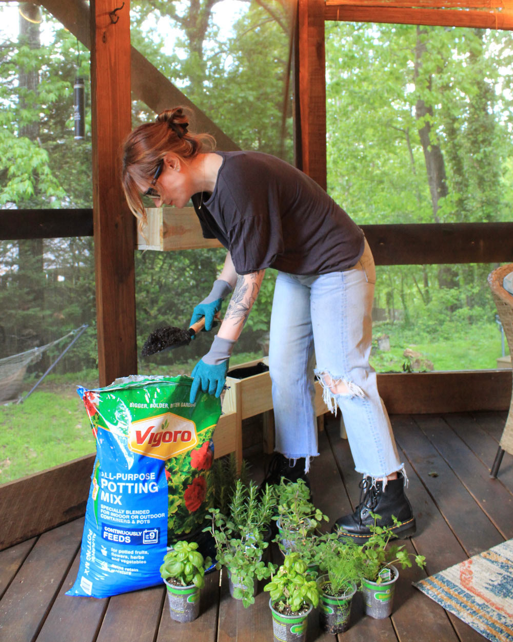 A woman scooping Vigoro potting mix into planter. A woman scooping Vigoro potting mix into planter.