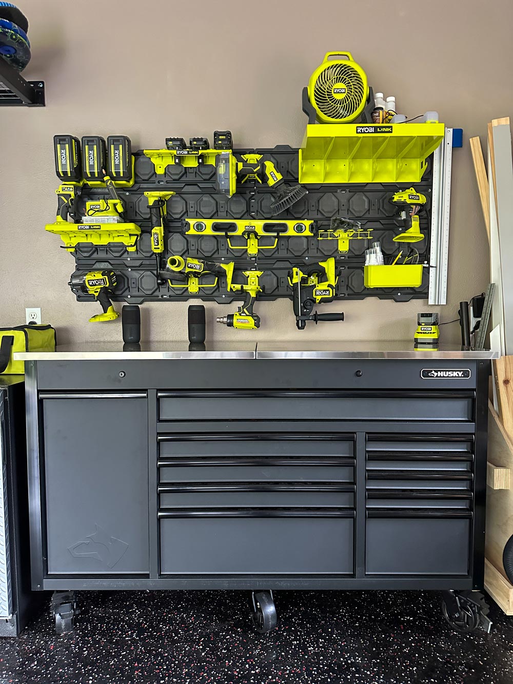 A Husky workbench, and a wall filled with Ryobi tools.