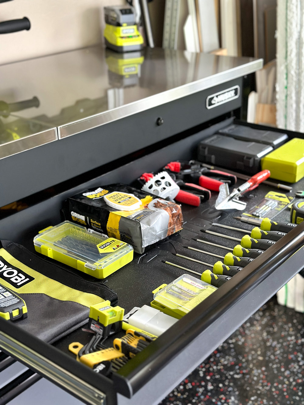 Husky workbench with a drawer opened showing small organized tools.