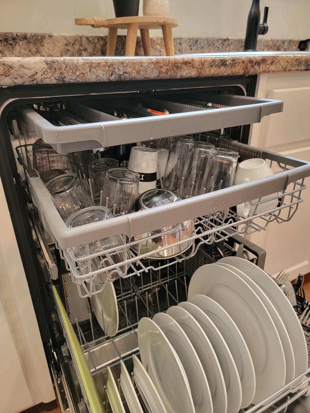 A new dishwasher filled with dishes.