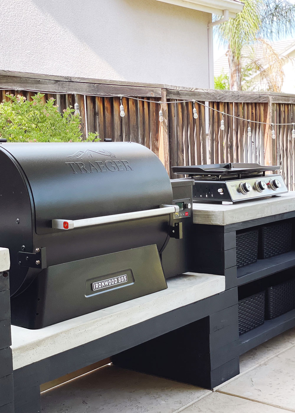 Black Traeger Grill and a stove top placed on a black and white custom countertop