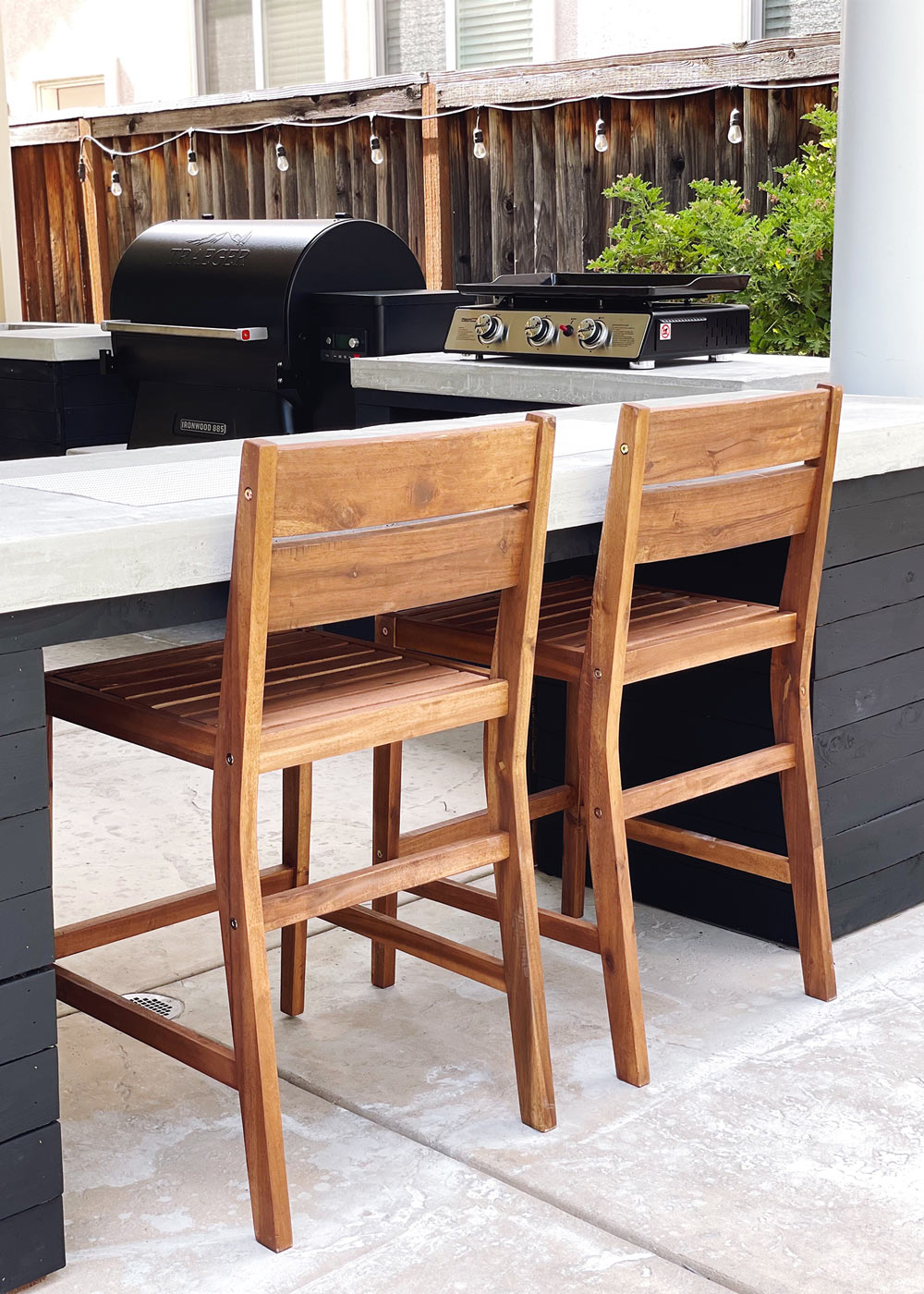 Two brown wooden chairs placed under a DIY countertop bar area