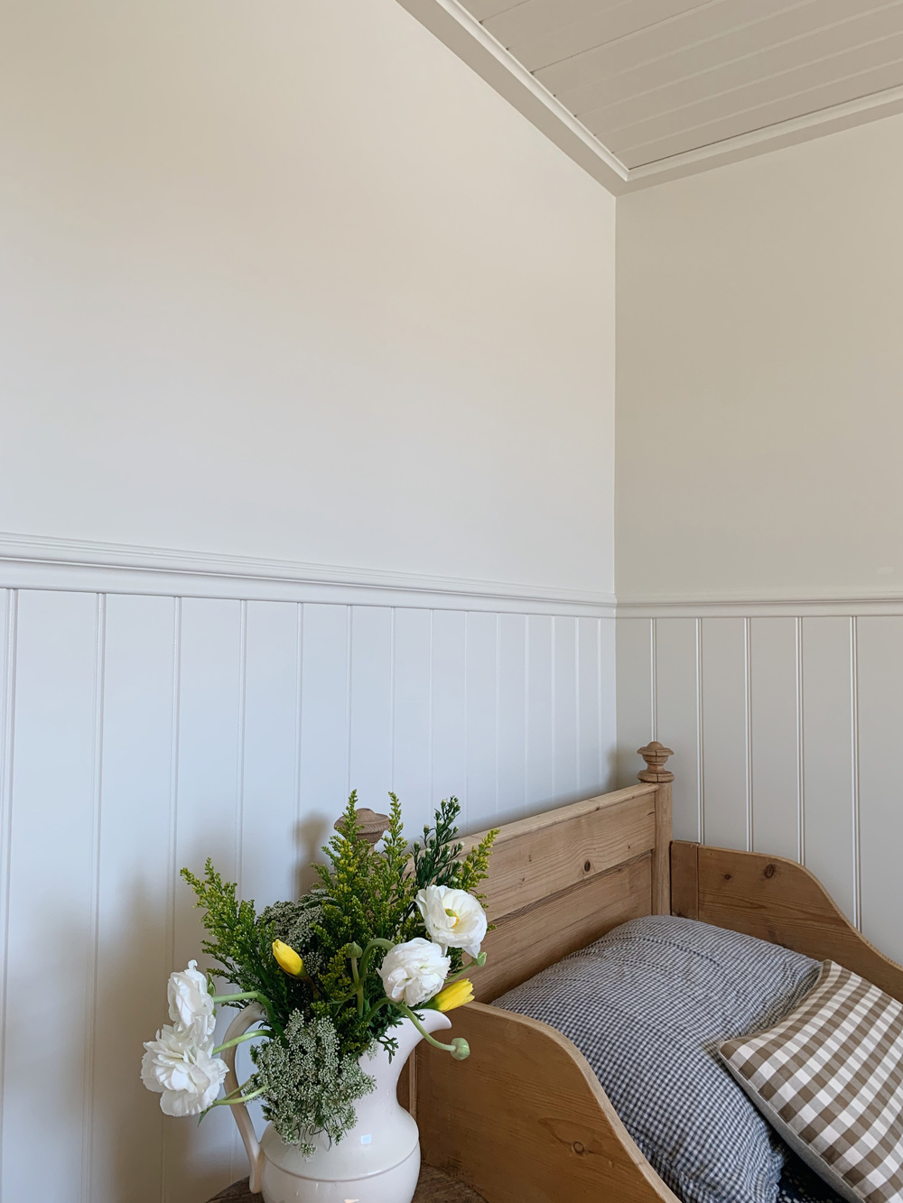 A shot of the walls, ceiling, and headboard of the bedroom.