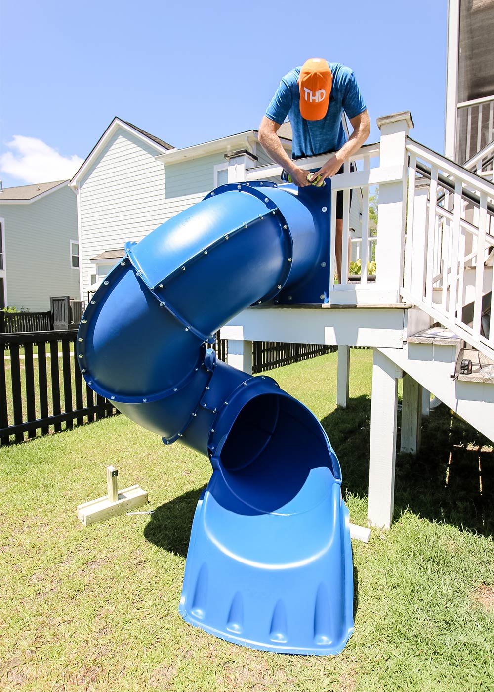Man installing blue slide off deck